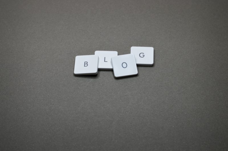 White buttons on a grey background that spell out 'BLOG'.